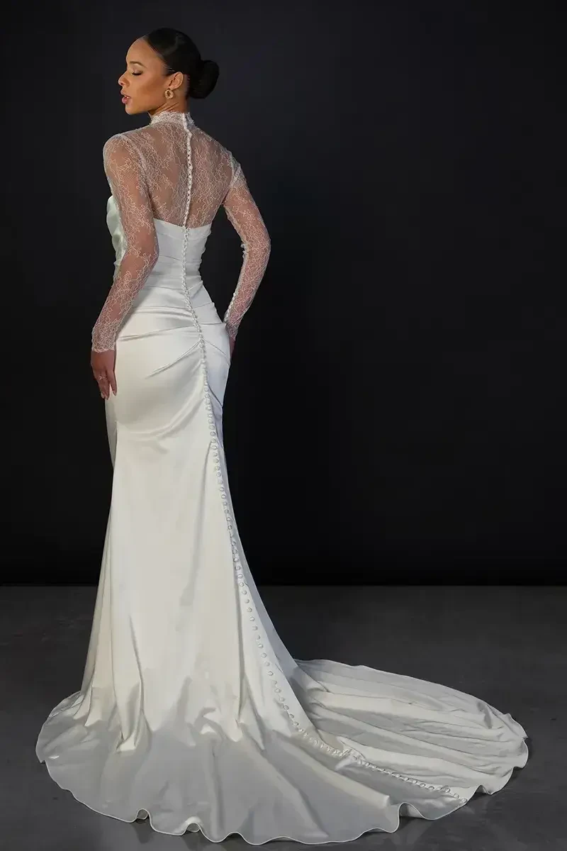 model is wearing a long sleeve high neckline wedding dress